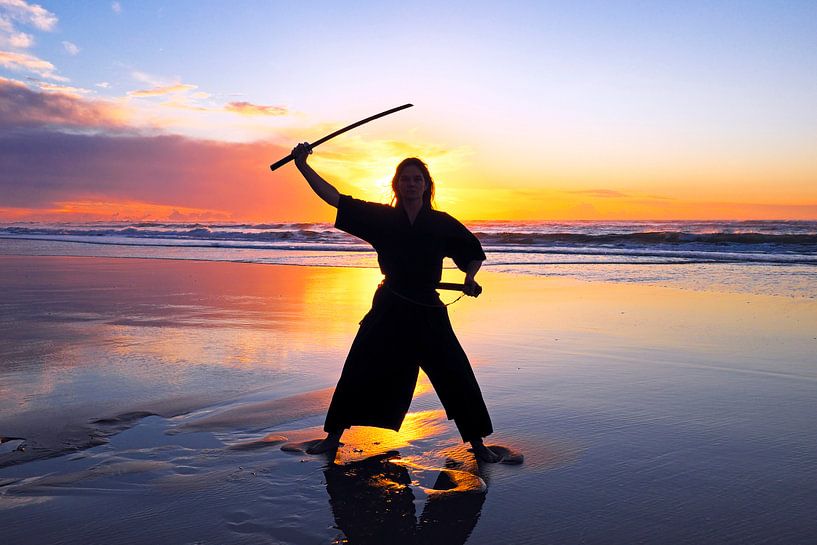 Samurai vrouw met Katana zwaard op het strand bij zonsondergang van Eye on You