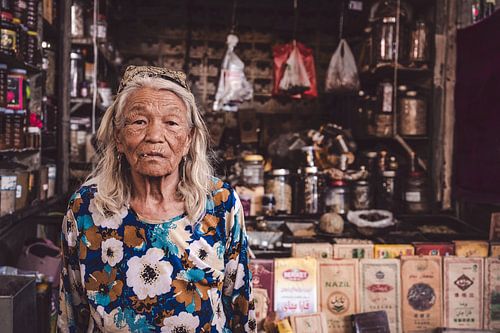 Portrait of an old woman on market in China