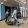 Image of cheese carriers at the cheese market in Edam by W J Kok