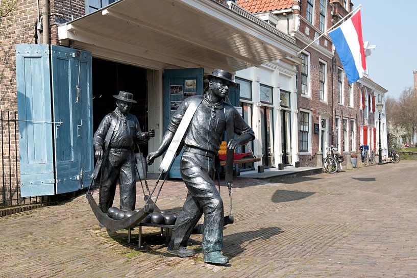 Image of cheese carriers at the cheese market in Edam by W J Kok