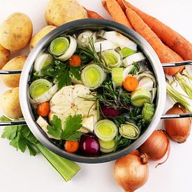 Bouillon avec carottes, oignons, divers légumes frais dans une marmite - soupe printanière claire et sur Beats