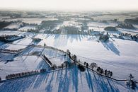 Een luchtfoto van een vroege ochtend boven een besneeuwd landschap in de Achterhoek van Jeroen Kleiberg thumbnail