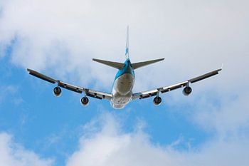 Departing Boeing 747 heading into the clouds