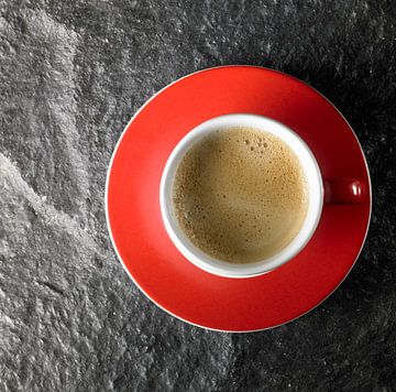 Red coffee cup on stone by Achim Prill