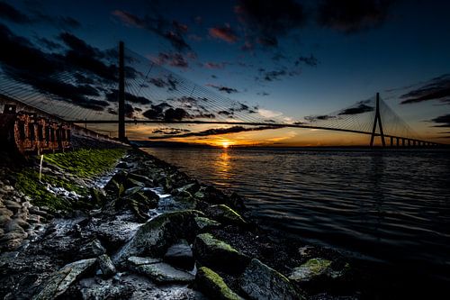 bridge of Normandy with an atmospheric sunset