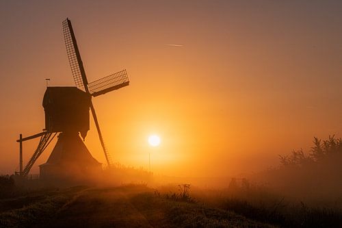 Mill at sunrise and fog