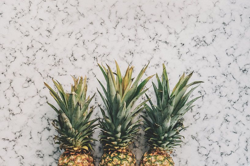 Three pineapples on white marble by MADK
