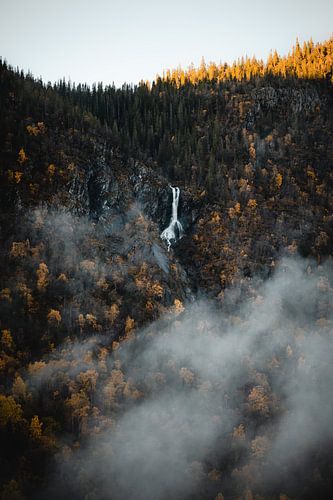Waterfall in Noose mountains surrounded by trees and autumn colours