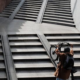 cyclist pushes her bike up by zeilstrafotografie.nl