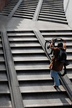 cyclist pushes her bike up by zeilstrafotografie.nl