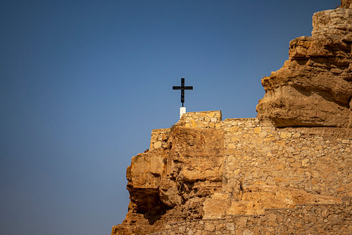 Cross on a sunny rocky outcrop