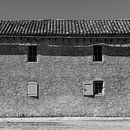 Black and white photo of an old  rural house with  shutters and tile roof in France by Dina Dankers thumbnail