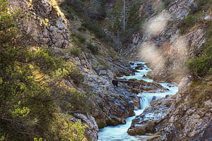 The Gleiersch Gorge in winter with snow, ice, and hanging icicles.