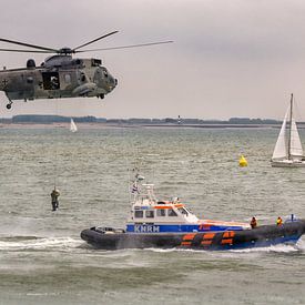 Dutch lifeboat and German Sea King helicopter by Roel Ovinge