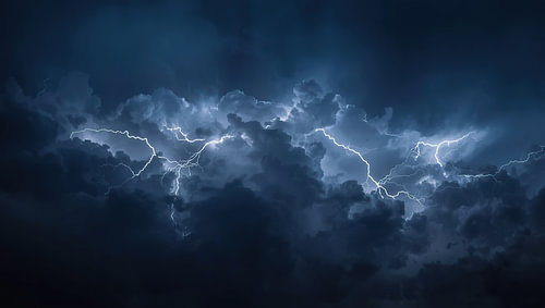 Lightning flashes in dark storm clouds.