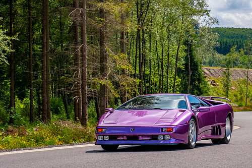 Lamborghini Diablo supercar driving through a forest