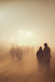 People walking in the mist during the Kumbh Mela in India
