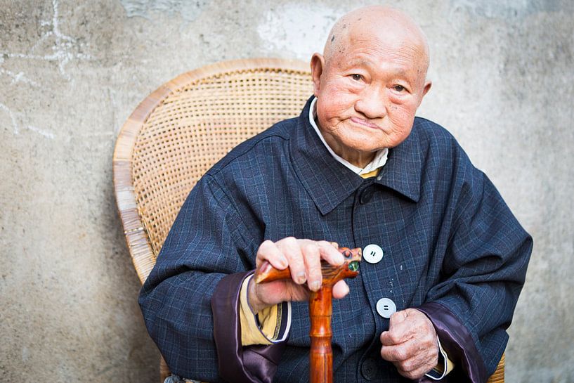 Portrait old man posing with walking stick in China by Ger Beekes