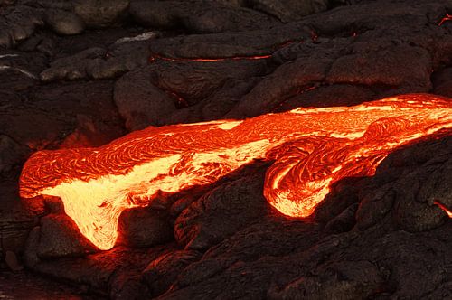 Glowing lava emerges from a fissure