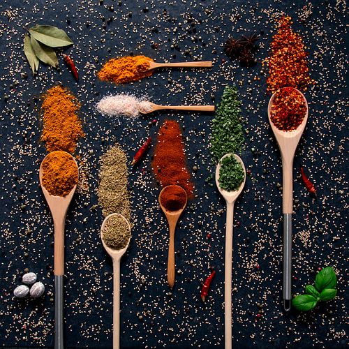 Cheerful colourful palette of spices and herbs on ladles