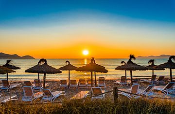 Beautiful sunset with orange sun over horizon on seaside beach by Alex Winter