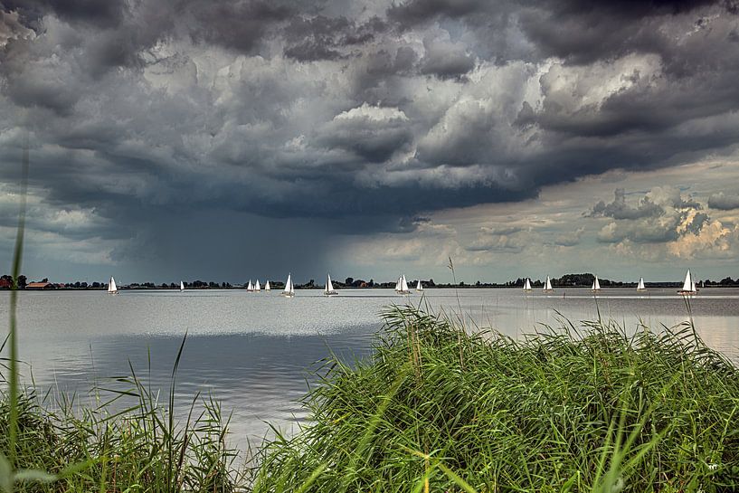 Idsegaasterpoel in Friesland with sailing boats and a threatening cloudy sky by Harrie Muis