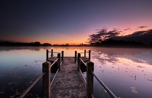 Jetty in lake before sunrise