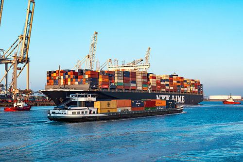 Barge passing cargo container ships at the container terminal in the port of Rotterdam by Sjoerd van der Wal Photography