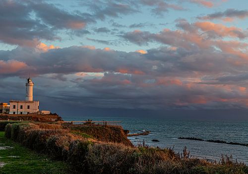 Lighthouse at sunset with clouds
