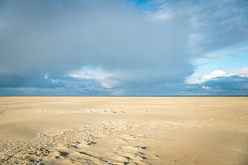 the large empty beach on the island of Texel with the horizon and dark clouds in the background by ChrisWillemsen