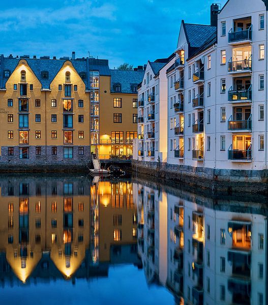 Evening lights reflecting on the harbour of Lesund, Norway by qtx