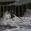 Wave splashes against the breakwaters on the coast of Zeeland by Marjolijn van den Berg