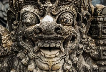 statue gods face hindu stone on bali indonesia by Dieter Walther