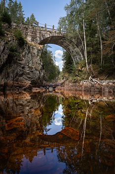 Schwedische Natur – Vertikaler Fotodruck der alten Steinbogenbrücke bei Brattfallet in Värmland