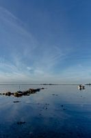 Travel photography - calm sea with rocks and a boat