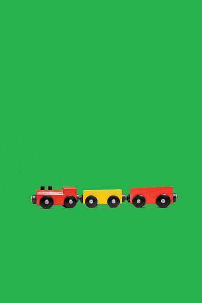 Wooden toy train on green background by Anton Hammenecker