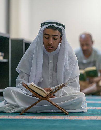 Young man in a mosque praying