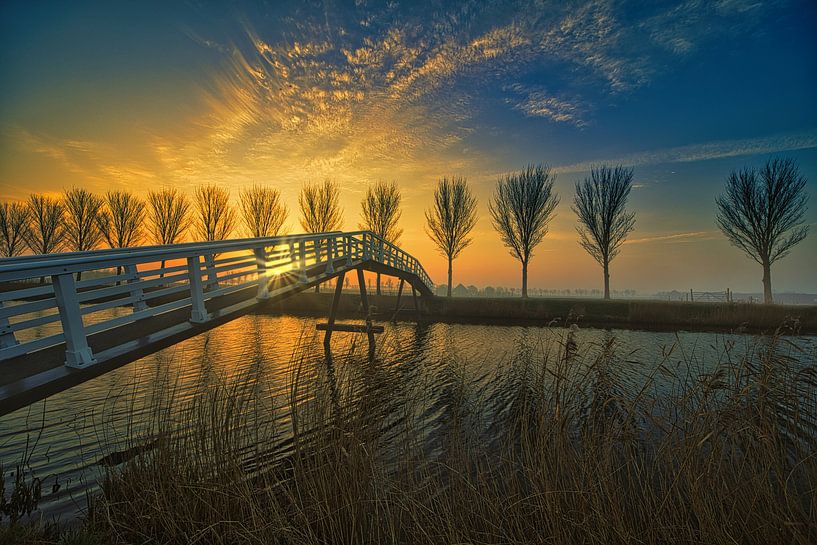 Bicycle bridge at sunrise near Avenhorn by peterheinspictures
