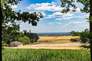 Eine malerische Aussicht: Rustikales Getreidefeld im Tal mit deutschem Bauernhaus von Remco Ditmar