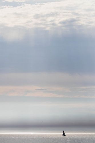 Sunbeams and sailing yacht at sea