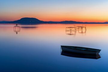 Panorama of beautiful sunrise at Lake Balaton in Hungary near Balatonfenyves with mountain Badacsony