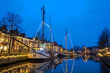 Decorated sailboats in the harbor of Dokkum in the Netherlands at sunset by Eye on You