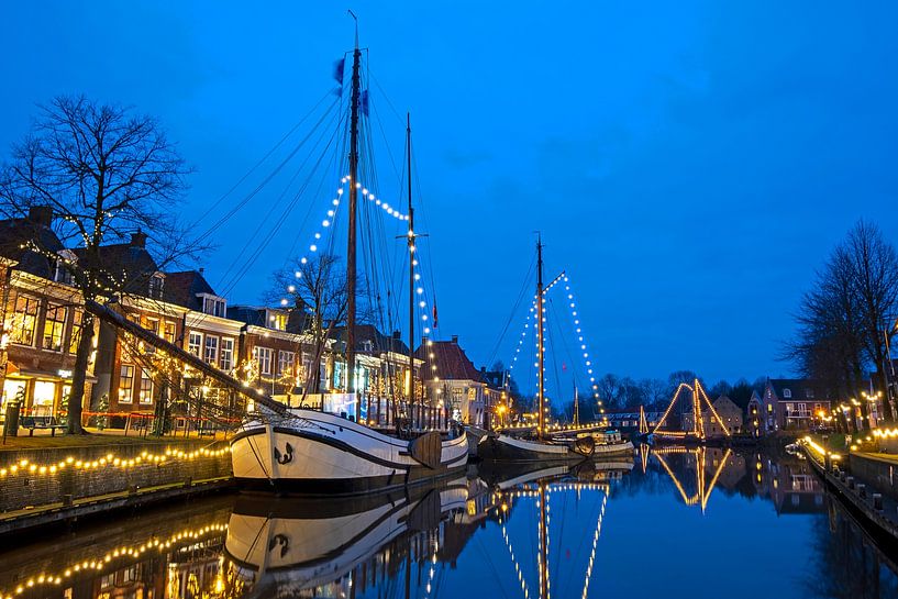 Decorated sailboats in the harbor of Dokkum in the Netherlands at sunset by Eye on You