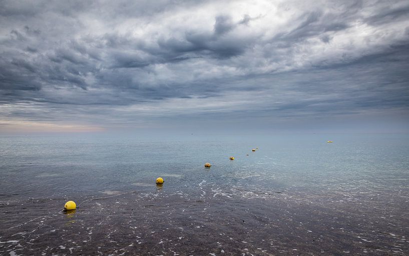 Row of buoys on the ocean against stormy sky by VIDEOMUNDUM