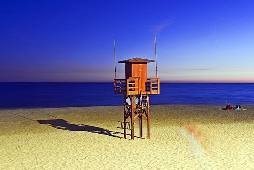 Summer night on the Atlantic coast with beach huts in Novo Sancti Petri