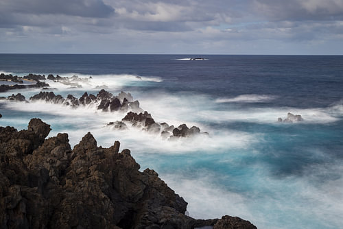 Spray over black rock