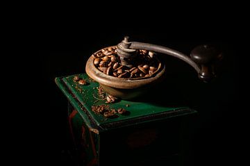 Old coffee grinder against black background by Werner Lerooy