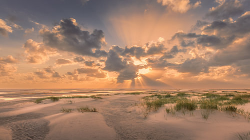 A golden sunset and beautiful clouds over Schiermonnikoog by Marga Vroom