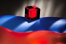 red cube on blue, orange wavy background. by Gerhard de Wit