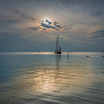 Ship at anchor in the IJsselmeer on a quiet summer evening near Hindeloopen by Harrie Muis